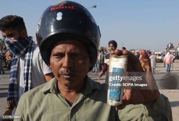 Protester holding an empty tear gas shell during the demonstration. Groups of farmers marched from Singhu border Delhi-Haryana border towards New...