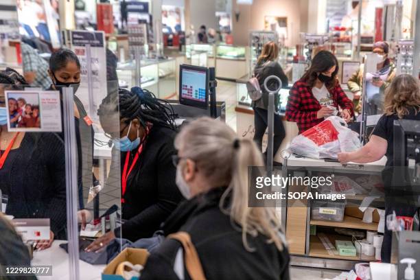 JCPenney employees checkout customers while following COVID-19 guidelines. Shoppers go to stores to take advantage of Black Friday sales during the...