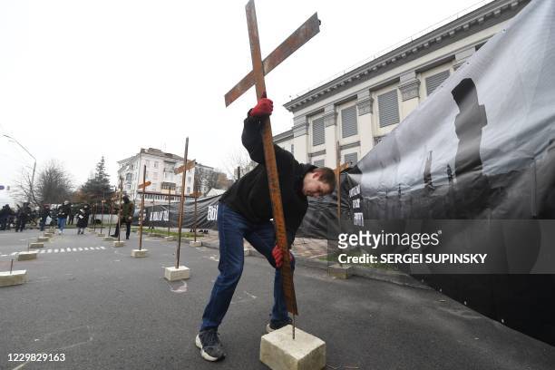 Ukrainian far-right activists set symbolic crosses outside Russian embassy in Kiev on November 28, 2020 during their protest action called "You...