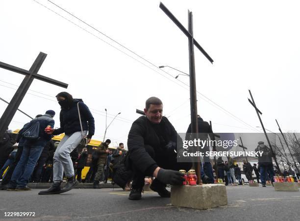 Ukrainian far-right activists set symbolic crosses outside Russian embassy in Kiev on November 28, 2020 during their protest action called "You...