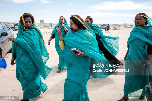 Women dressed in the colours of Mauritanias national flag gather to watch the military parade and celebrations for the sixtieth anniversary of...