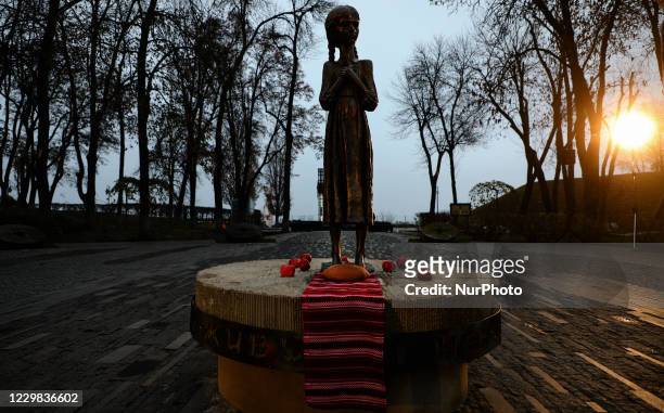 People lit candles and lay bouquets from ears ang arrowwood to the memorial of Great Famine victims during mourning rally in Kyiv, Ukraine, November...