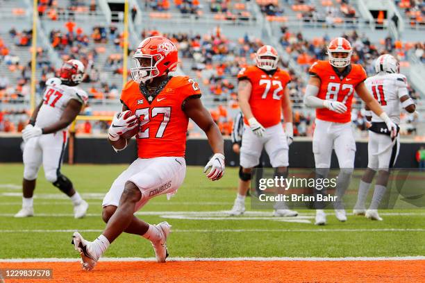 Running back Dezmon Jackson of the Oklahoma State Cowboys steps into the endzone for a touchdown after following outside the center against the Texas...