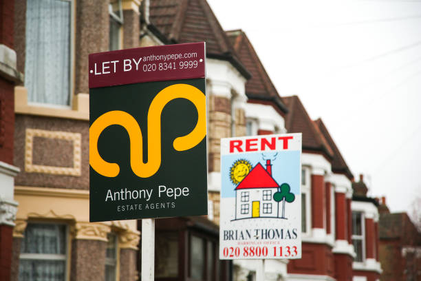 To Let' and "Rent" estate agent board sign erected outside a property in London.
