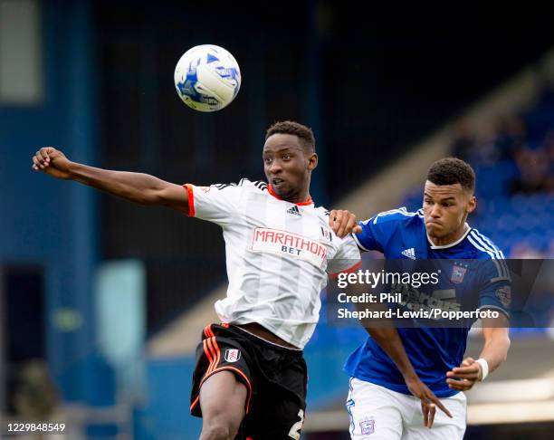 Moussa Dembele of Fulham controls the ball under pressure from Tyrone Mings of Ipswich Town during a Sky Bet Championship match at Portman Road on...