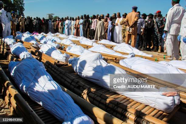 Mourners attend the funeral of 43 farm workers in Zabarmari, about 20km from Maiduguri, Nigeria, on November 29, 2020 after they were killed by Boko...