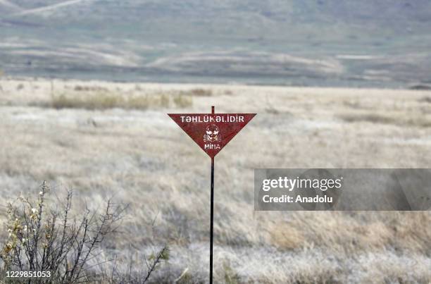 Sign translates "Danger" on a road between Tartar and Suqovusan as demining works are underway after the area was liberated by Azerbaijani army near...