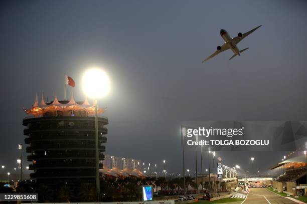 Gulf Air Boeing 787-9 "Dreamliner" aircraft passes over the track ahead of the Bahrain Formula One Grand Prix at the Bahrain International Circuit in...