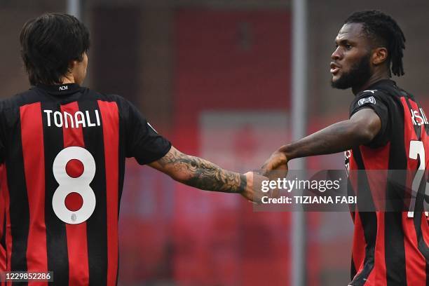 Milan's Ivorian midfielder Franck Kessie celebrates with AC Milan's Italian midfielder Sandro Tonali after scoring a penalty during the Italian Serie...