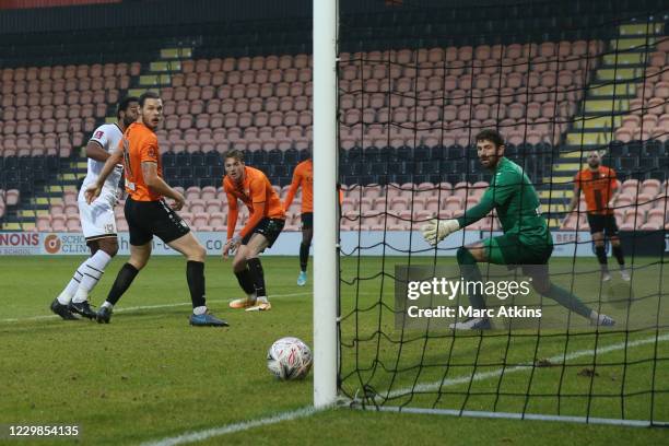 Cameron Jerome of MK Dons scores the winning goal during the Emirates FA Cup Second Round match between Barnet FC and Milton Keynes Dons at The Hive...