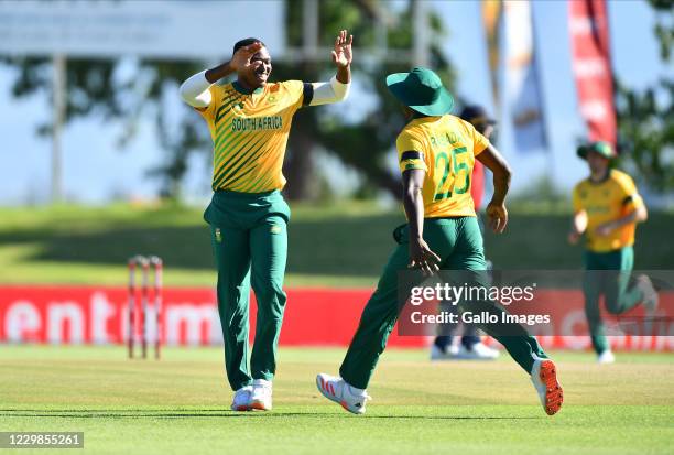 Lungi Ngidi celebrates with Kagiso Rabada of South Africa after dismissing Jason Roy of England during the 2nd KFC T20 International match between...