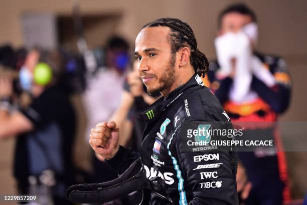 Mercedes' British driver Lewis Hamilton gestures after winning the Bahrain Formula One Grand Prix at the Bahrain International Circuit in the city of...