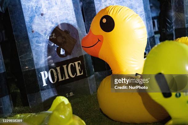 An inflatable rubber ducks in front of riot police during a protest to calling the prime minister to resign and reforms the in the monarchy outside...