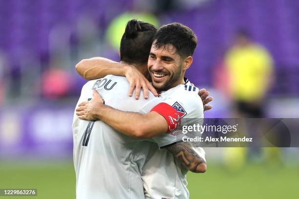 Gustavo Bou of New England Revolution and Captain Carles Gil hug after defeating the Orlando City SC during the MLS Eastern Conference Semifinal...