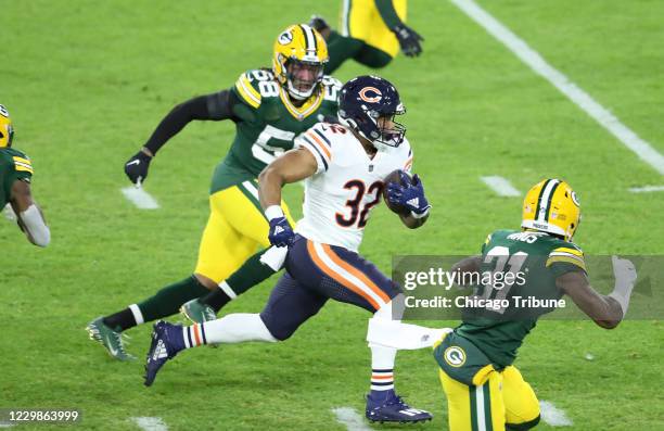 Chicago Bears running back David Montgomery runs with the ball after making a reception in the first quarter against the Green Bay Packers on Sunday,...