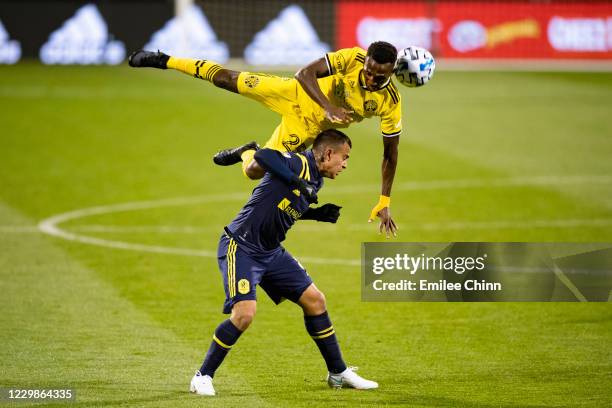 Harrison Afful of Columbus Crew heads the ball over Randall Leal of Nashville SC during the first half of the MLS Eastern Conference semifinal game...