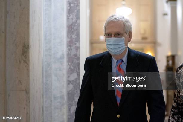 Senate Majority Leader Mitch McConnell, a Republican from Kentucky, wears a protective mask while departing from the U.S. Capitol in Washington,...