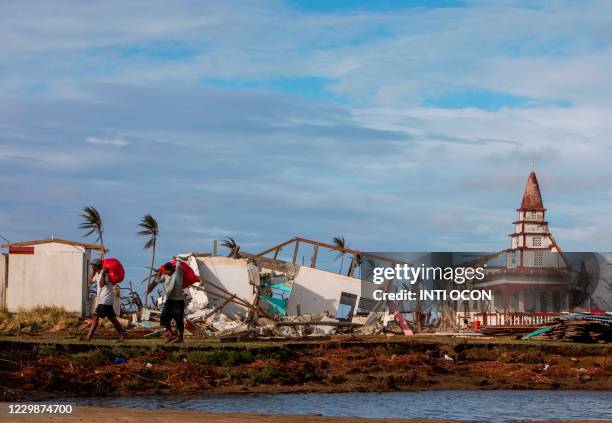 Men carry their belongings in bags as they return to Haulover, a community 41 km south of Bilwi, in the Northern Caribbean Autonomous Region,...