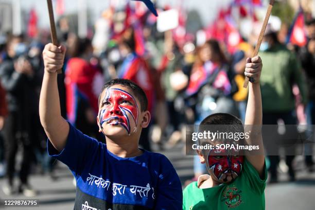 Nepalese boys with national flags painted on their faces seen during a pro-monarchy demonstration. Pro-monarchy protesters gathered in Kathmandu...