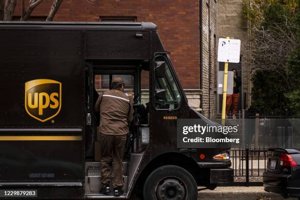 United Parcel Service Inc. Driver unloads package in the Lincoln Park neighborhood of Chicago, Illinois, U.S., on Monday, Nov. 30, 2020. Online...