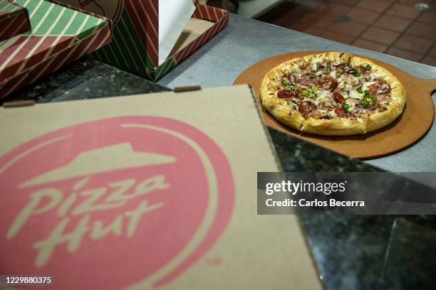 Pizza is ready for a delivery at a Pizza Hut store in Las Mercedes on November 30, 2020 in Caracas, Venezuela. CryptoBuyer has become Pizza Hut's...