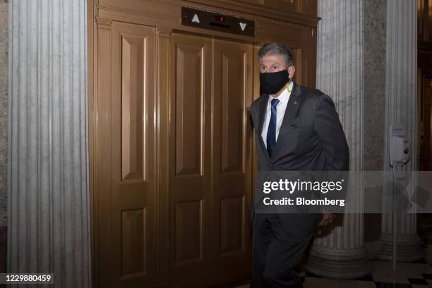 Senator Joe Manchin, a Democrat from West Virginia, wears a protective mask while walking to the Senate Floor at the U.S. Capitol in Washington,...