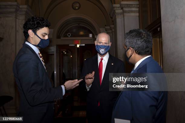 Senator Rick Scott, a Republican from Florida, center, wears a protective mask while speaking with members of the media at the U.S. Capitol in...