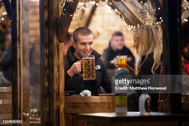 Man drinks from a glass of beer at Christmas markets on December 01, 2020 in Cardiff, Wales. From Friday at 6pm licensed pubs, cafes and restaurants...