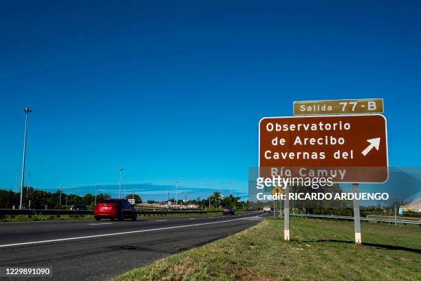 An indicative road sign towards the Arecibo Observatory is seen on the highway in Arecibo, Puerto Rico on December 1, 2020. - The Arecibo Observatory...