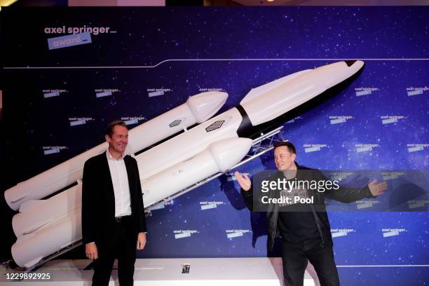 SpaceX owner and Tesla CEO Elon Musk poses next to Axel Springer's Chairman of the Board Mathias Doepfner on the red carpet of the Axel Springer...