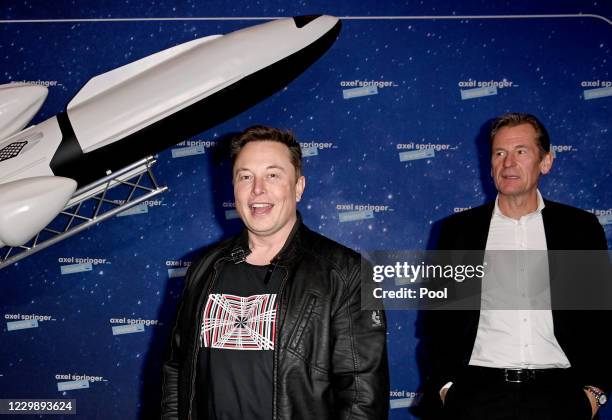 SpaceX owner and Tesla CEO Elon Musk poses next to Axel Springer CEO Mathias Doepfner on the red carpet of the Axel Springer Award 2020 on December...