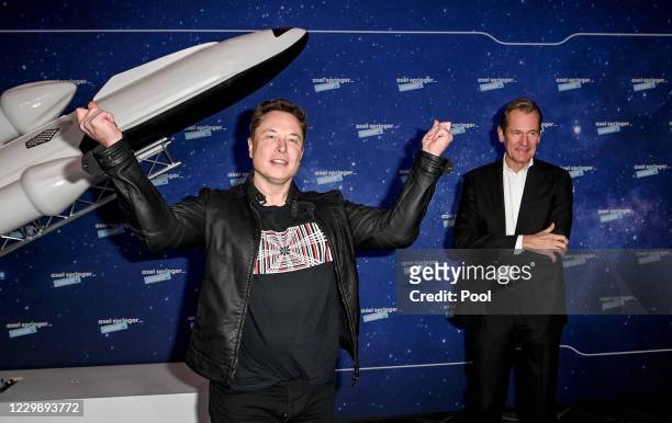 SpaceX owner and Tesla CEO Elon Musk poses next to Axel Springer CEO Mathias Doepfner on the red carpet of the Axel Springer Award 2020 on December...