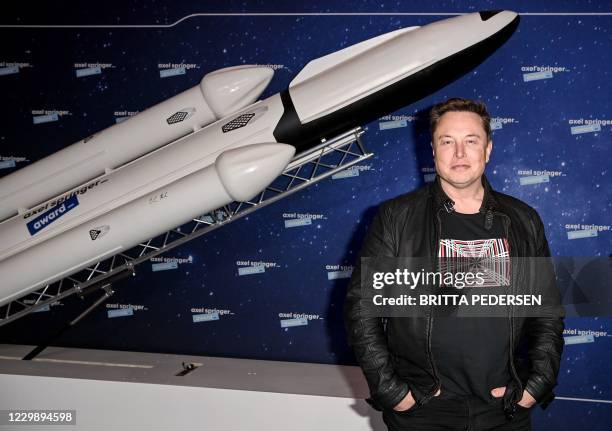 SpaceX owner and Tesla CEO Elon Musk gestures as he arrives on the red carpet for the Axel Springer Awards ceremony, in Berlin, on December 1, 2020.