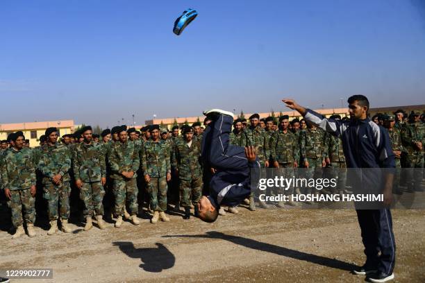 An Afghan National Army soldier demonstrates his skills during a graduation a ceremony in a military base in the Guzara district of Herat province on...