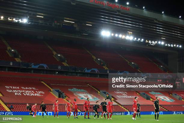 Players tussle for position in front of empty seats during the UEFA Champions League Group D stage match between Liverpool FC and Ajax Amsterdam at...
