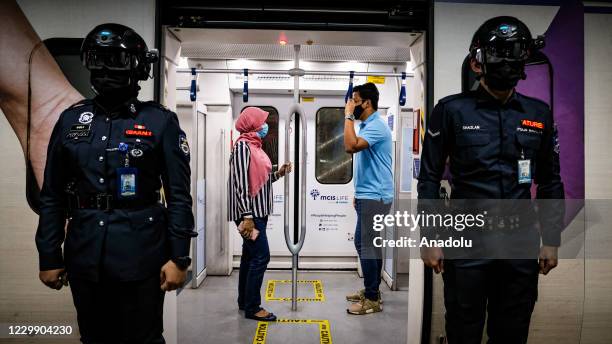 Officers of Keretapi Tanah Melayu Berhad wear a special helmet that able to scan the temperature of civilians at KL Sentral, Kuala Lumpur, Malaysia...