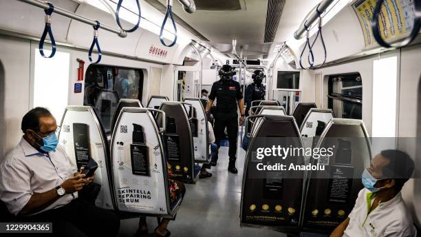 Officers of Keretapi Tanah Melayu Berhad wear a special helmet that able to scan the temperature of civilians at KL Sentral, Kuala Lumpur, Malaysia...