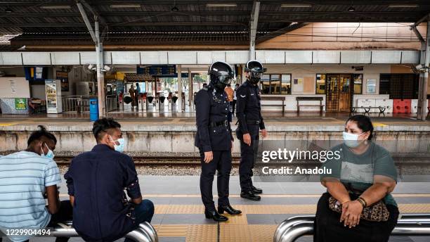 Officers of Keretapi Tanah Melayu Berhad wear a special helmet that able to scan the temperature of civilians at KL Sentral, Kuala Lumpur, Malaysia...