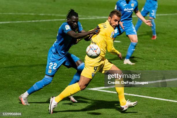 Pathe Ciss of CF Fuenlabrada and Orlando Carlos Braga de Sa of Malaga CF battle for the ball during the La Liga SmartBank match between Fuenlabrada...