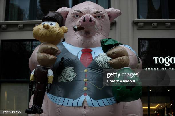 View of an inflatable animal model resembling rich boss is seen during a protest called "Protect Amazon Workers" against the CEO Jeff Bezos amid...