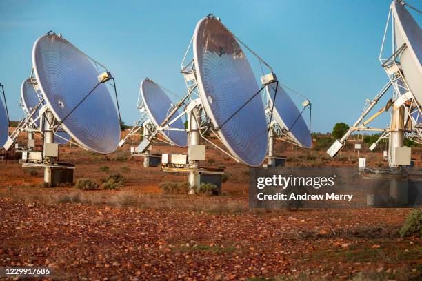 solar thermal power station with parabolic dish reflector in red dirt field, outback australia - solar physics observatory stock pictures, royalty-free photos & images