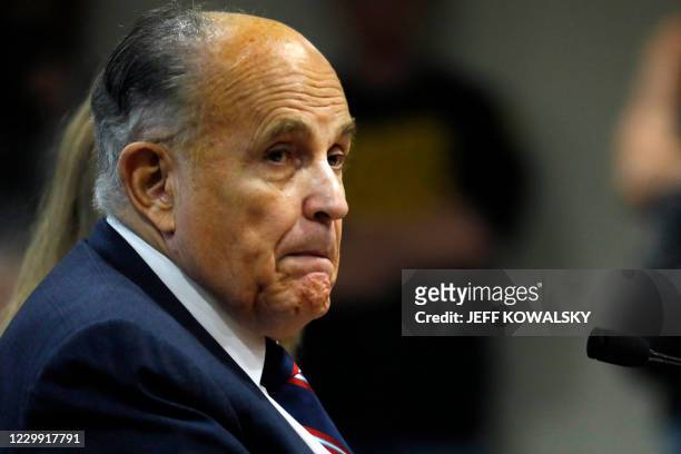 Rudy Giuliani, personal lawyer of US President Donald Trump, looks on during an appearance before the Michigan House Oversight Committee in Lansing,...