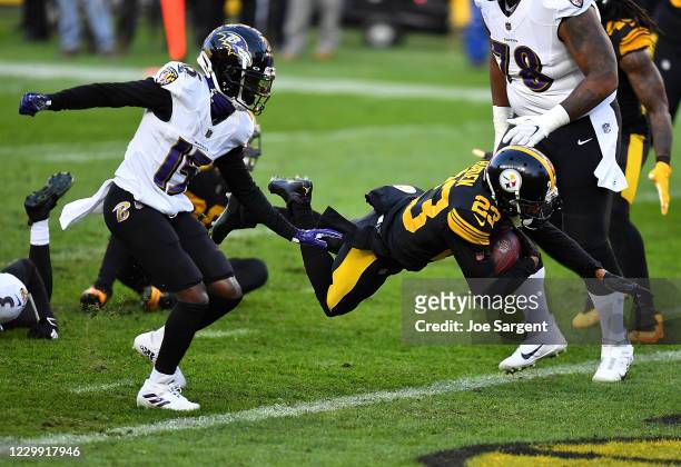 Joe Haden of the Pittsburgh Steelers carries the ball for a touchdown after intercepting a pass during the first quarter against the Baltimore Ravens...