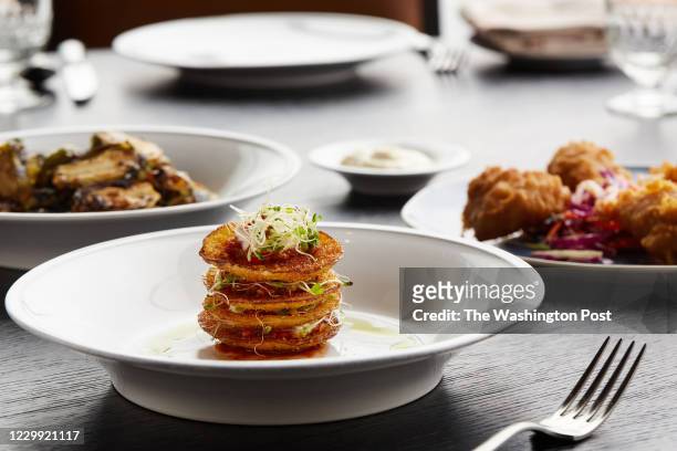 Smaller plates include from left to right: Roasted Brussels Sprouts with Honey & Soy Glaze and Benne Seeds, Fried Green Tomatoes Stack with Pimento...