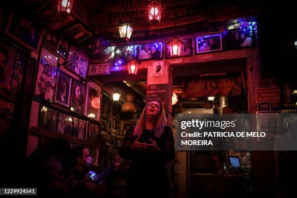 Fado singer Claudia Picado , Portuguese guitarist Pedro Dias and classic guitarist Carlos Vicoso perform at "Tasca do Chico" fado house in the Bairro...