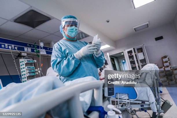 Medical worker wears personal protective equipment and perform her duties during a shift inside the Intensive Critical Unit for critical patients...