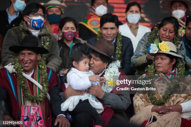 Former president of Bolivia Evo Morales holds a child during a welcome ceremony at Santa Rosa neighborhood on December 3, 2020 in El Alto, Bolivia....