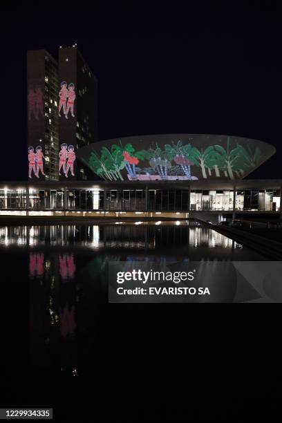 View of images projected by the NGO Instituto Socioambiental on the National Congress building in Brasilia, on December 3 to mark the beginning of...
