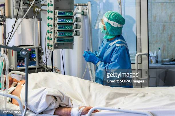 Nurse wearing personal protective equipment operates a medical equipment inside the Intensive Care Unit at the Bochnia Hospital. The Central Eastern...