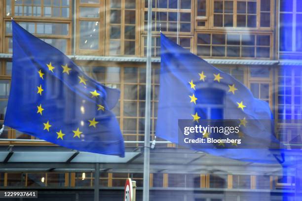 European Union flags fly outside the Berlaymont building, headquarters of the European Commission, in Brussels, Belgium, on Friday, Dec. 4, 2020....